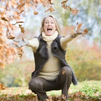 woman throwing leaves