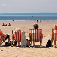 senior group women deckchairs beach